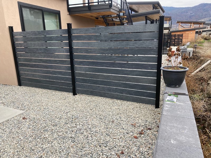 Fence rails in recycled plastic lumber on an acreage