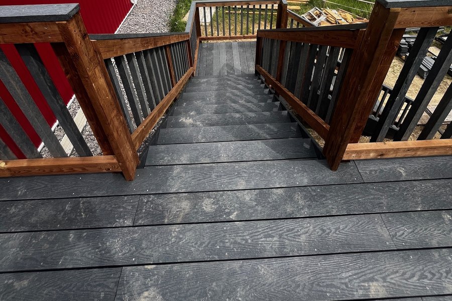 Recycled plastic deck and stairs at a farm shop, with paddock, corral panels and a horse beyond